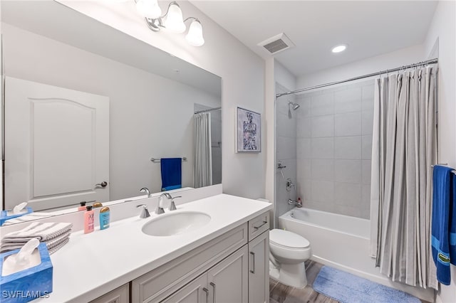 full bathroom featuring shower / tub combo with curtain, wood-type flooring, vanity, and toilet