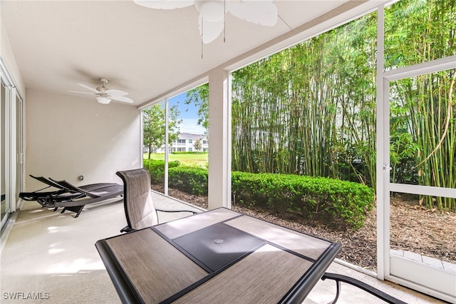 unfurnished sunroom with ceiling fan