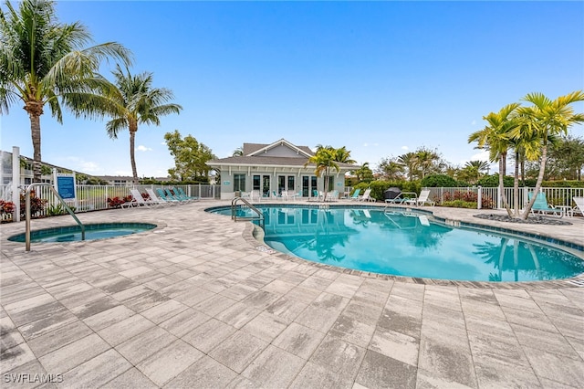 view of swimming pool with a community hot tub and a patio