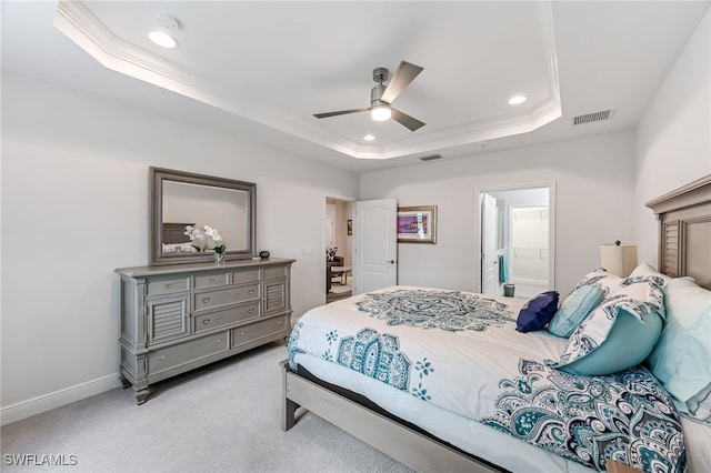 carpeted bedroom featuring crown molding, ceiling fan, a tray ceiling, and connected bathroom