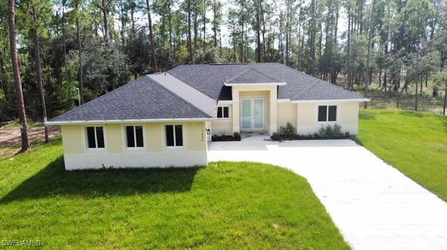 view of front of home featuring a front yard and french doors