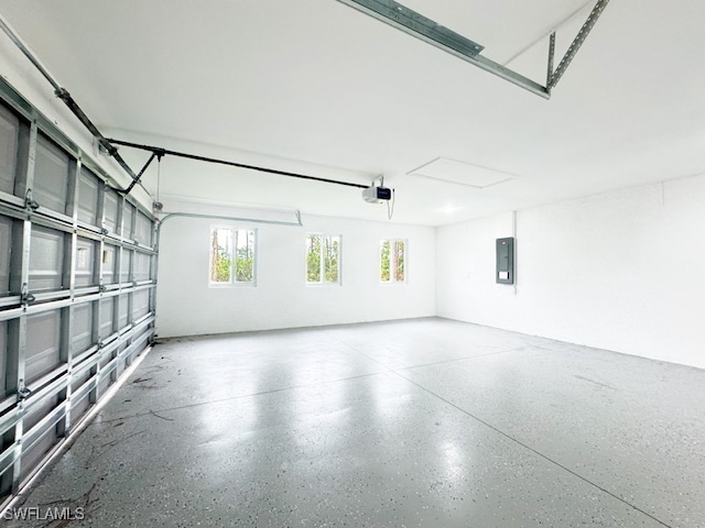 garage with electric panel and a garage door opener