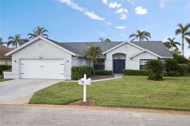 ranch-style house featuring a garage and a front lawn