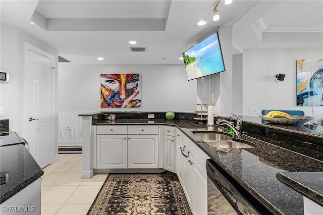 kitchen with white cabinetry, a tray ceiling, and sink