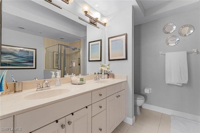 bathroom with a shower with door, vanity, toilet, and tile patterned flooring