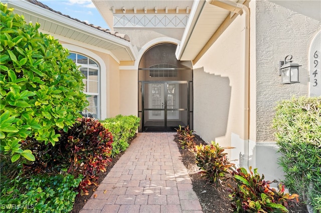 view of exterior entry featuring french doors