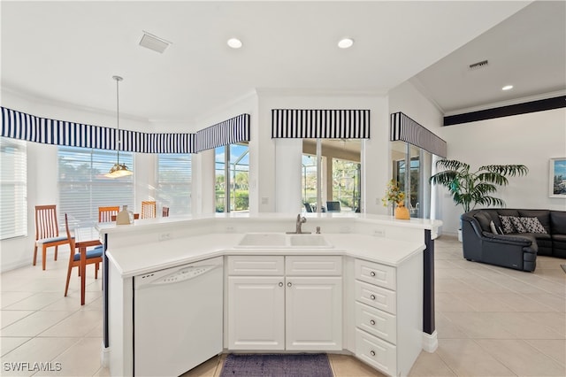 kitchen with pendant lighting, dishwasher, white cabinets, crown molding, and sink