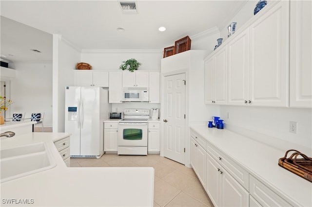 kitchen with white cabinets, white appliances, crown molding, and sink