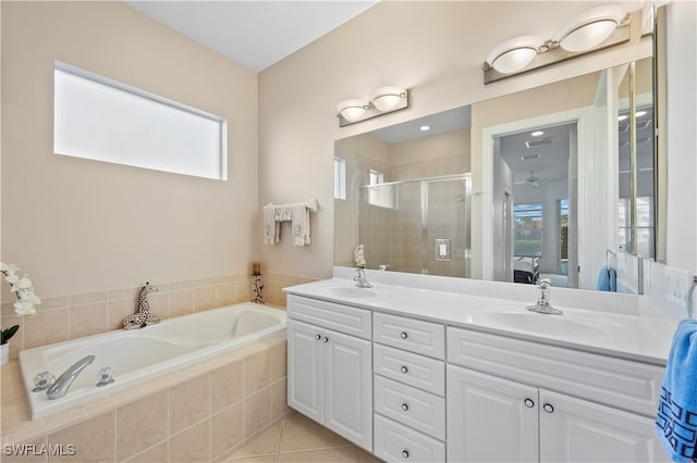 bathroom with plus walk in shower, tile patterned flooring, and vanity