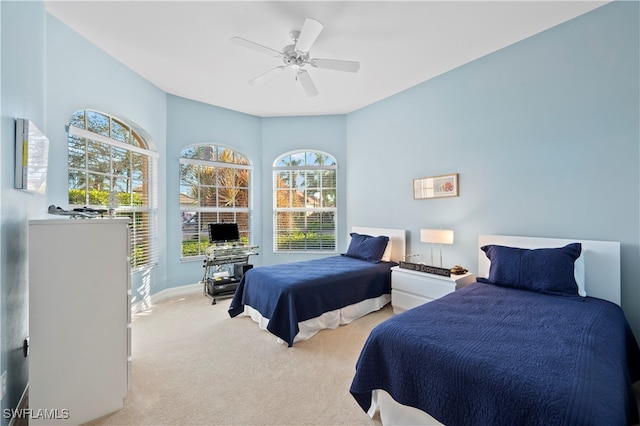 bedroom featuring ceiling fan and light colored carpet