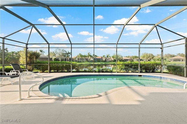 view of pool with a patio, a water view, and a lanai