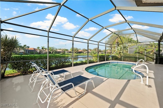 view of swimming pool with a lanai, a patio area, and a water view