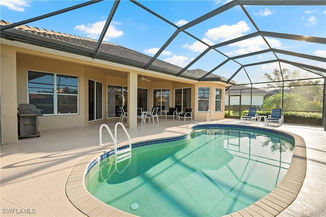 view of swimming pool featuring a patio, ceiling fan, a lanai, and grilling area