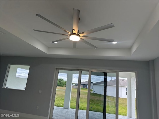 room details with a raised ceiling and ceiling fan