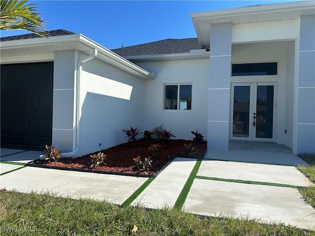 exterior space featuring french doors and a garage