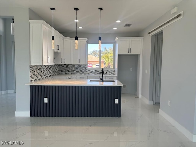 kitchen featuring white cabinetry, sink, decorative backsplash, and pendant lighting