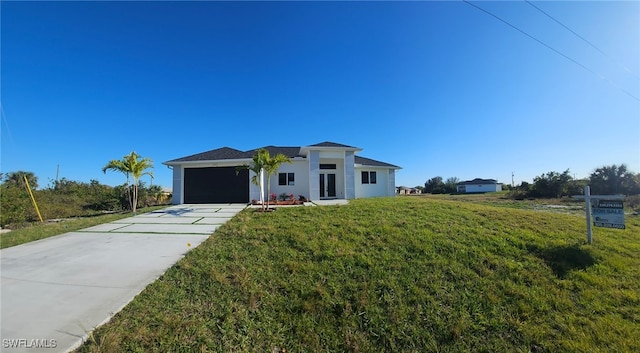 view of front facade with a garage and a front yard