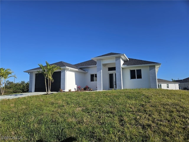 view of front of property with a garage and a front yard