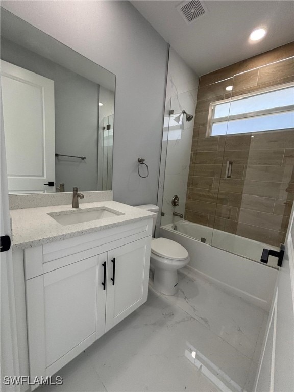 full bathroom with toilet, vanity, and shower / bath combination with glass door