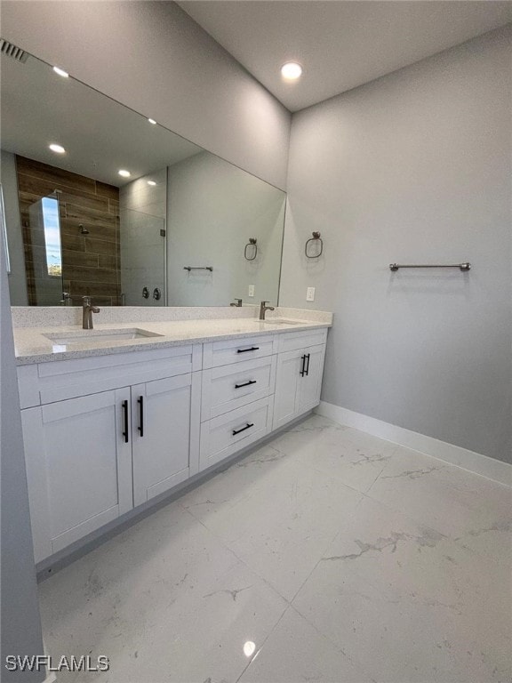 bathroom with vanity and tiled shower