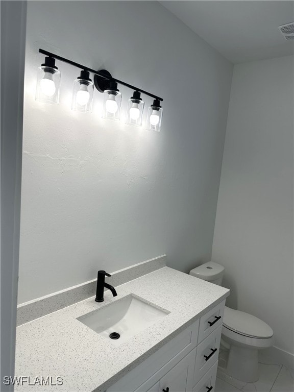 bathroom featuring vanity and toilet