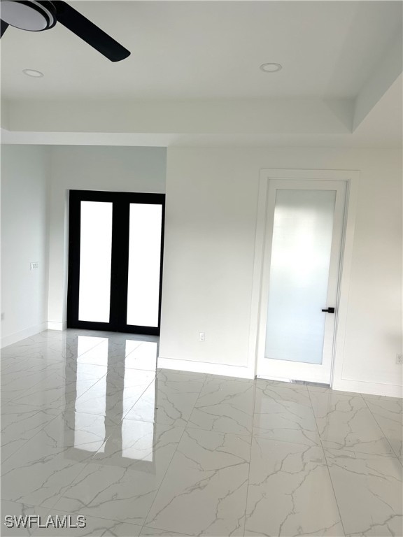 unfurnished room featuring plenty of natural light and ceiling fan