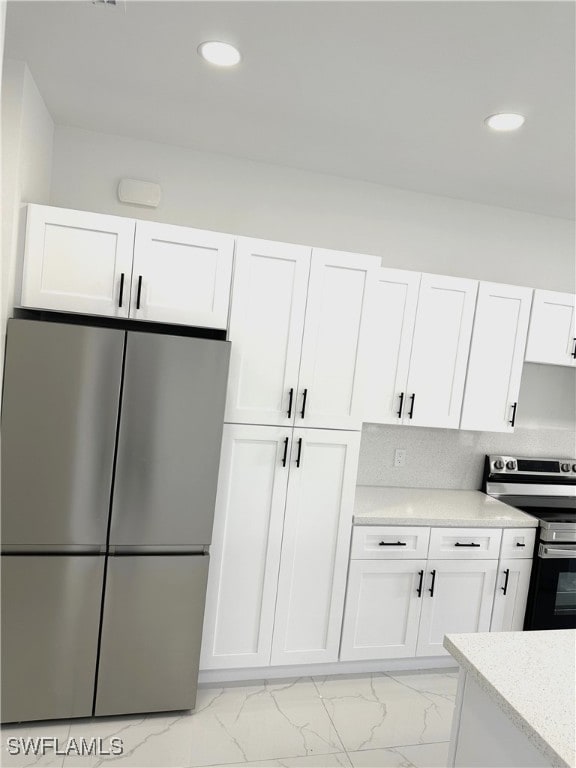 kitchen featuring white cabinets and appliances with stainless steel finishes