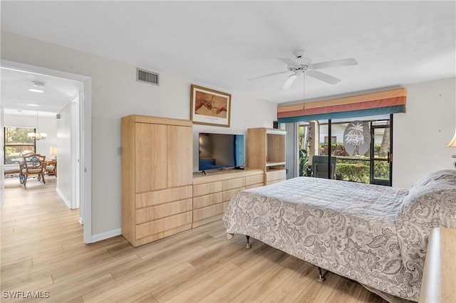 bedroom with access to outside, multiple windows, ceiling fan, and light wood-type flooring