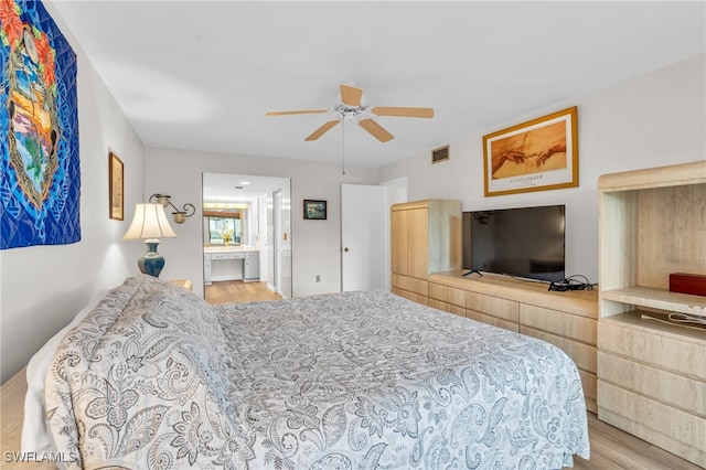 bedroom with ensuite bath, ceiling fan, and light hardwood / wood-style flooring