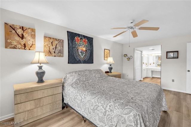 bedroom featuring ensuite bathroom, a ceiling fan, wood finished floors, and baseboards