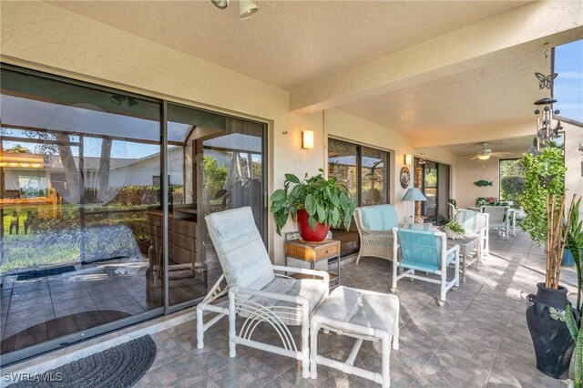 sunroom / solarium with ceiling fan and outdoor dining area