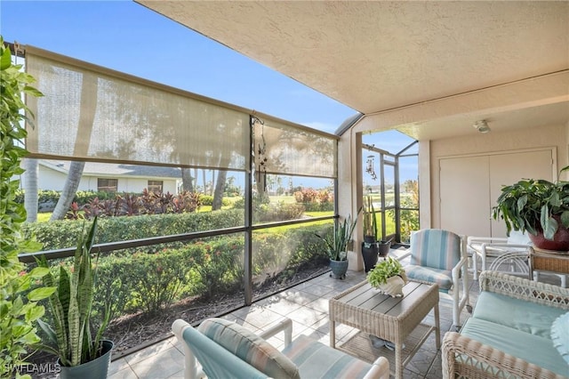 sunroom / solarium with an outdoor hangout area, a textured ceiling, and floor to ceiling windows