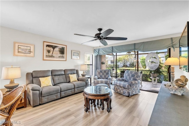 living room featuring ceiling fan and light wood-type flooring