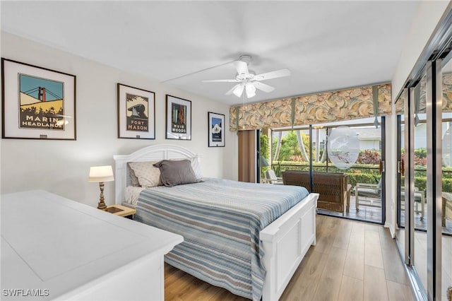 bedroom with ceiling fan, light wood finished floors, and access to outside