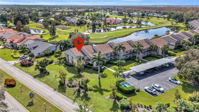 aerial view with view of golf course, a water view, and a residential view