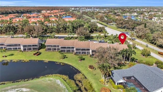 aerial view with a residential view, a water view, and golf course view