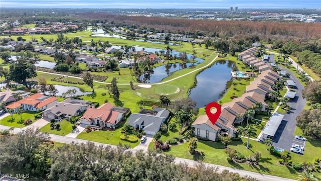 drone / aerial view with a residential view, view of golf course, and a water view