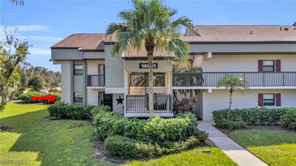 14501 Aeries Way Dr Unit 111, Fort Myers, FL 33912 - exterior space with stucco siding, roof with shingles, a front yard, and a balcony