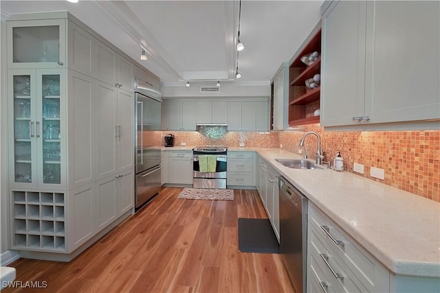 104 Wilderness Dr Unit 341, Naples, FL 34105 - kitchen with light wood-style floors, rail lighting, open shelves, a sink, and stainless steel appliances