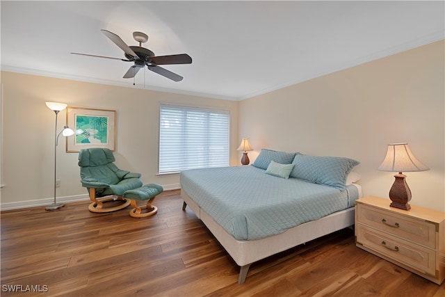 bedroom featuring ceiling fan, ornamental molding, and dark wood-type flooring