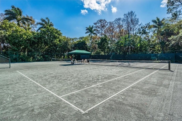 104 Wilderness Dr Unit 341, Naples, FL 34105 - view of tennis court with fence