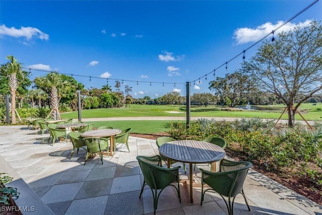 104 Wilderness Dr Unit 341, Naples, FL 34105 - view of patio with outdoor dining space and view of golf course