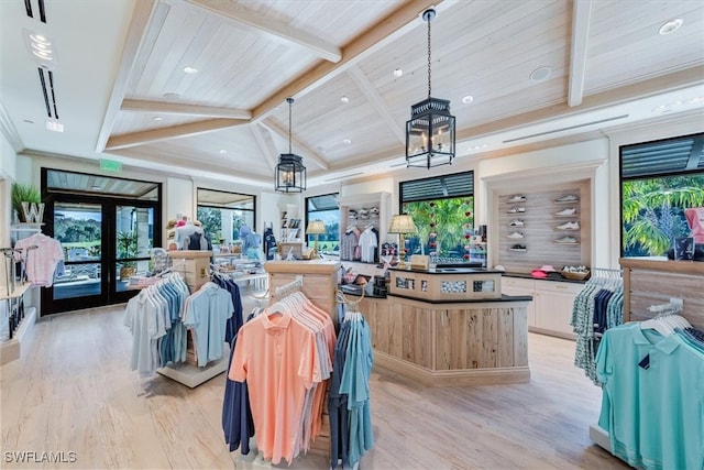 kitchen with pendant lighting, wood ceiling, beam ceiling, french doors, and light wood-type flooring