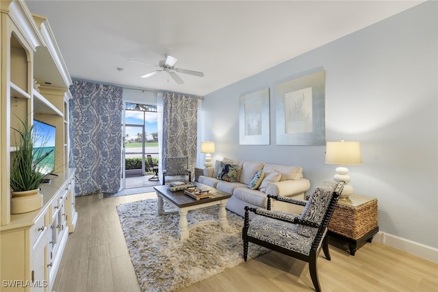 living room with ceiling fan and light wood-type flooring