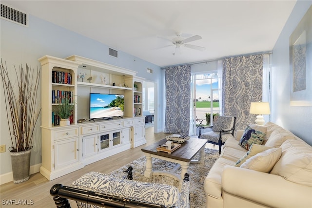 living room with ceiling fan and light hardwood / wood-style flooring