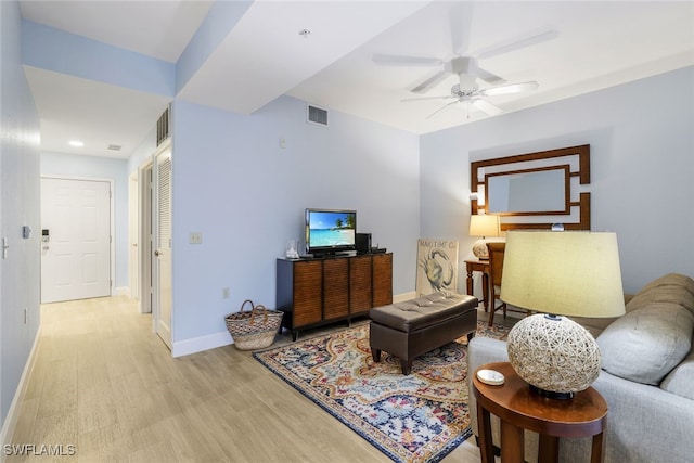 living room featuring light hardwood / wood-style flooring and ceiling fan