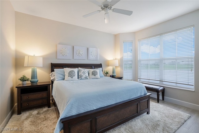 bedroom with ceiling fan and light hardwood / wood-style floors