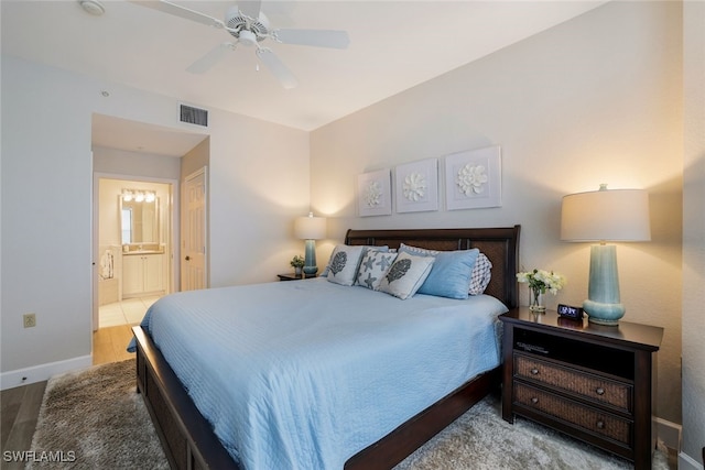 bedroom featuring ceiling fan, connected bathroom, and hardwood / wood-style flooring