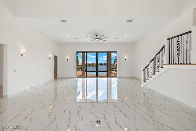 interior space with ceiling fan