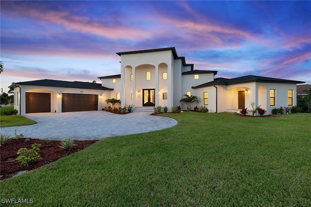 view of front facade with a garage and a yard